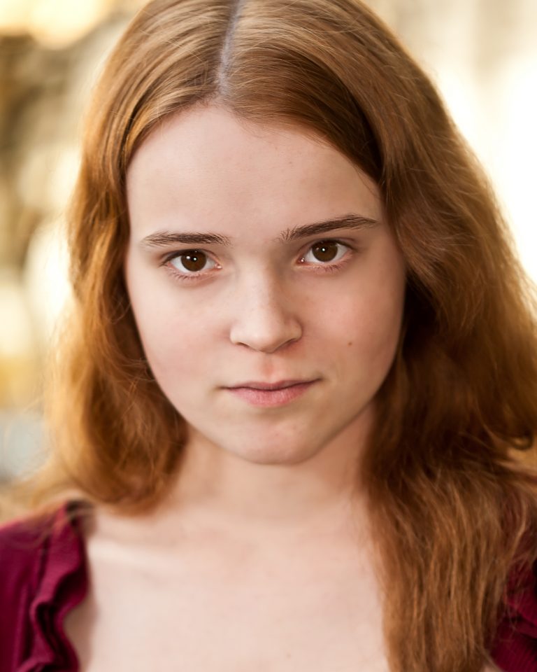 Theatrical headshot of young actress with red hair – Headshots NYC